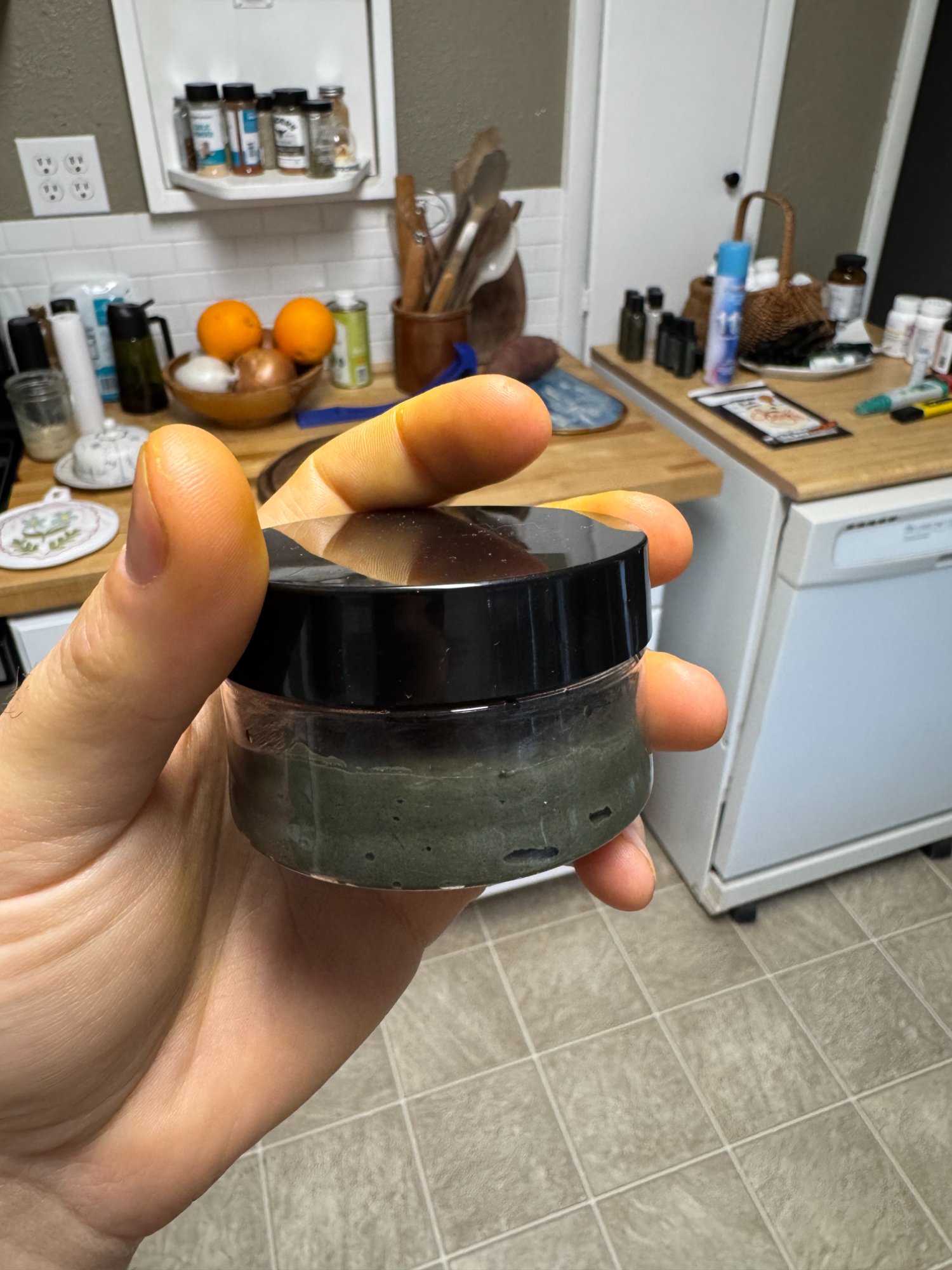 Side view of Gator Mud jar showing dark green product